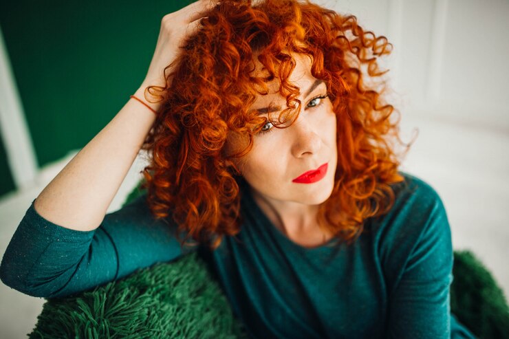 woman with frizz-free beautiful curly red hair